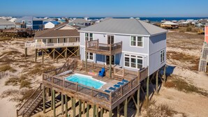 A beachfront house with a pool, wooden deck, and multiple levels. - Gulf Front, Private Heated Pool, Pet Friendly, 2 Master Suites! – Island Time IV (Dauphin Island)