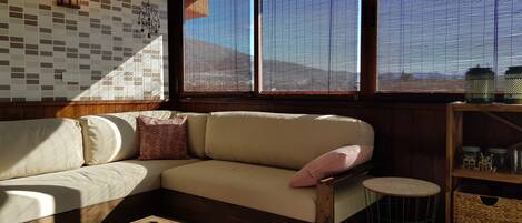 A living room with a sofa, a coffee table, and a small round table.