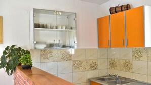 A kitchen with a wooden countertop, a sink, and orange cabinets. - Apartment in Vir with Terrace, Air condition, WIFI (4592-1) (Vir)