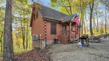 Escape to a tranquil retreat surrounded by nature, with a cozy porch and grill for outdoor cooking.