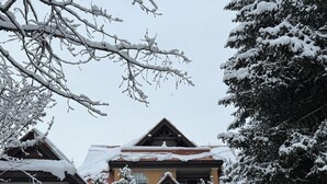 A snow-covered building with a stone entrance and a sign indicating 'SUNPATH Northlands Blvd.'