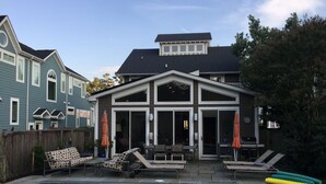 A backyard with a swimming pool, lounge chairs, and a covered patio area. - 6 Bed/5 Bath with Pool - upgraded beds for 2026 (Rehoboth Beach)