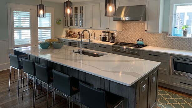 A modern kitchen with a large island, bar stools, stainless steel appliances, and pendant lighting. - 6 Bed/5 Bath with Pool - upgraded beds for 2026 (Rehoboth Beach)