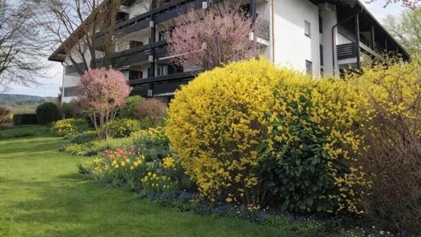 A multi-story building with balconies, surrounded by well-maintained gardens and trees. - °Ferienwohnung Hedy mit 1 sep. Schlafzimmer, Südterrasse, 55 qm (Prien am Chiemsee)