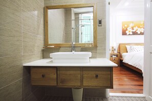 Deep-soaking bathtub, hydromassage showerhead, designer toiletries