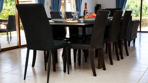 A dining area with a table set for six, including wine glasses, plates, and cutlery. - Stunning 4 Bedroom Villa -Private Pool - Sea View (Peyia)