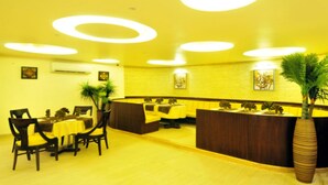 A reception area with a wooden reception desk, several chairs, and potted plants.
