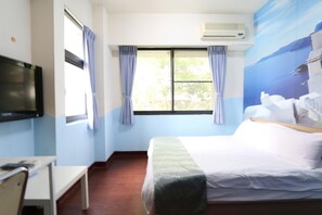 A hotel room with a bed, a desk, a television, and a window with curtains. - Feng Chia Love Heart (Taichung)