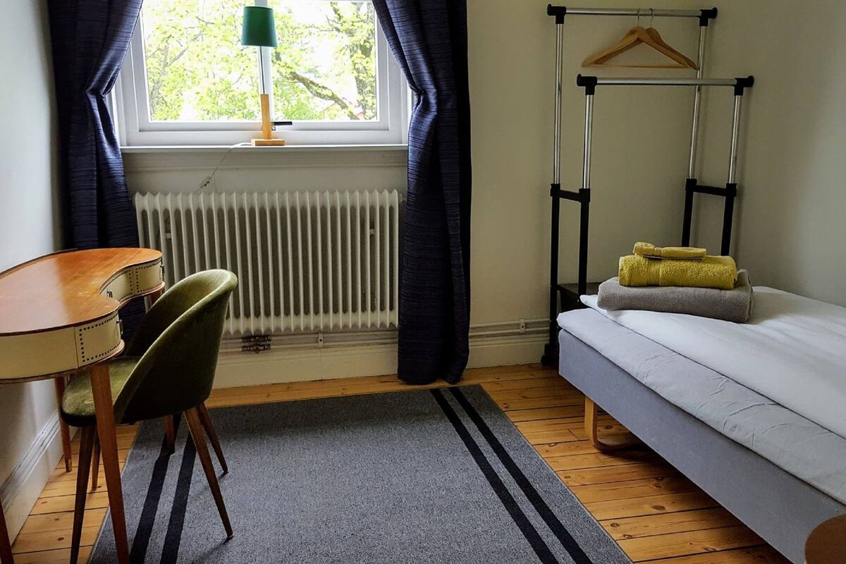 A compact room with a bed, a desk, and a chair.