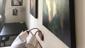 A room with a bed, a desk, and two framed artworks on the wall. - Hagbackens GĂ„rd Bed & Breakfast (Ărebro)