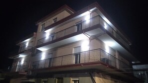 A multi-story building with balconies and exterior lighting. - Campo Sportivo (Taurianova)