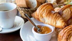 A table with croissants, a cup of coffee, and a small bowl of jam. - Campo Sportivo (Taurianova)