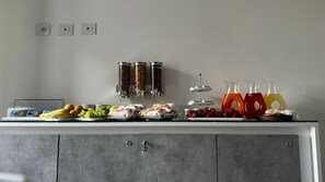 A buffet setup with food items and beverages. - Campo Sportivo (Taurianova)