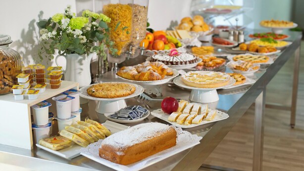 A buffet with a variety of food items including pastries, fruits, and desserts. - Porto Salvo (Sant'Agnello)