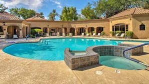 A swimming pool with a sunken hot tub, lounge chairs, and a covered patio area. - Ultra-Clean, Designer Condo. Walk to grocery, restaurants, coffee, and shopping! (Scottsdale)
