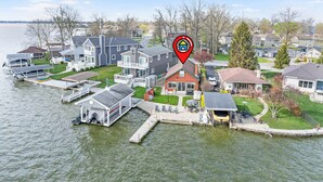 A residential area with houses, a dock, and a body of water.