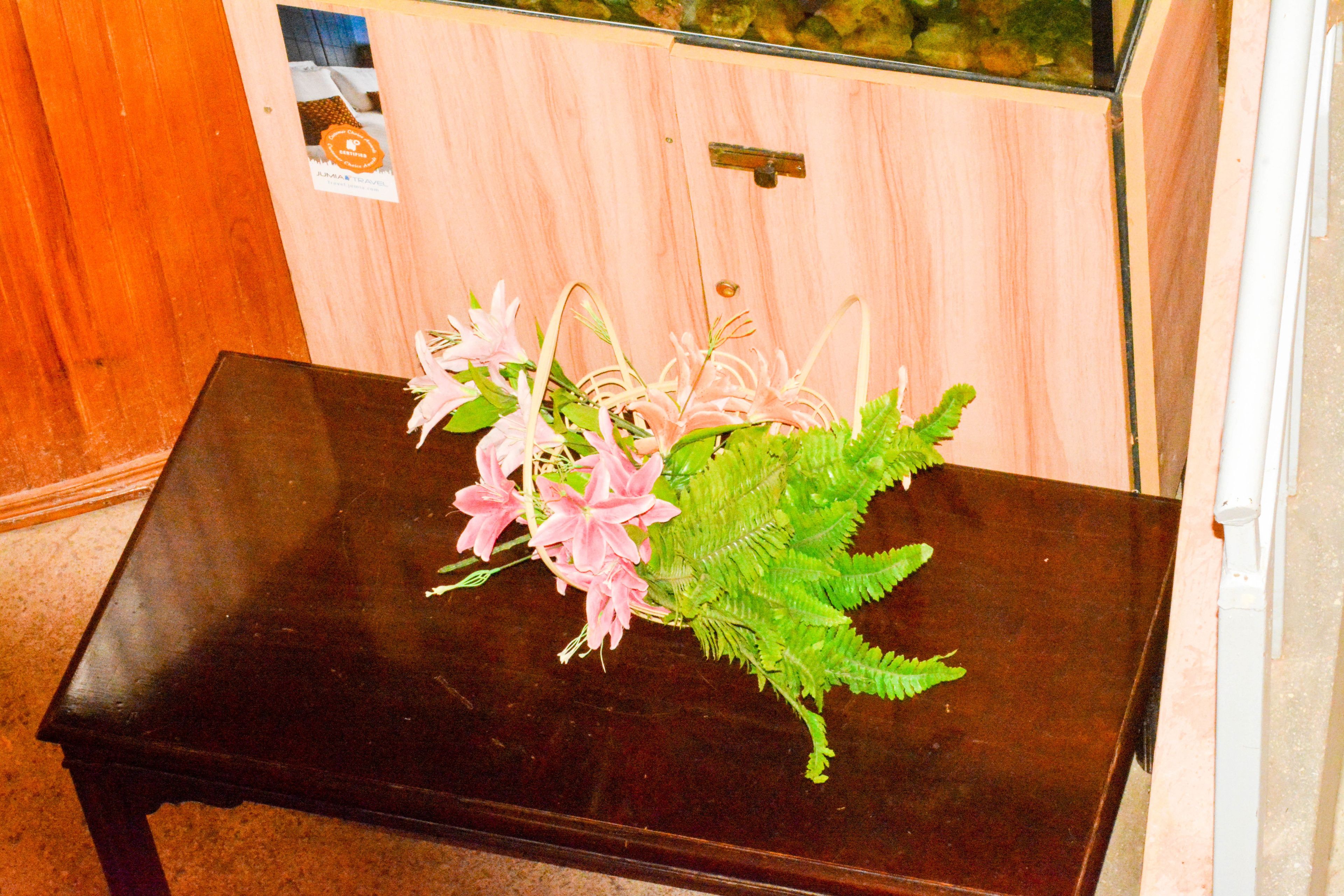 A dark wooden table with a floral arrangement.