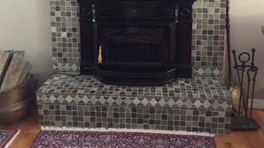 A fireplace with a mosaic tile surround, a framed picture above it, and a wooden mantel. - 4BR, 2 level, comfortable House In Kennebunkport/Cape Porpoise Maine.  (Kennebunkport)