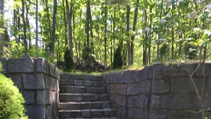A stone staircase leading up to a stone wall, surrounded by greenery and trees. - 4BR, 2 level, comfortable House In Kennebunkport/Cape Porpoise Maine.  (Kennebunkport)