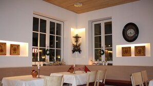 A dining area with tables and chairs, a wall clock, and framed pictures on the walls. - Hotel Gasthof Goldener Adler (Horb am Neckar)