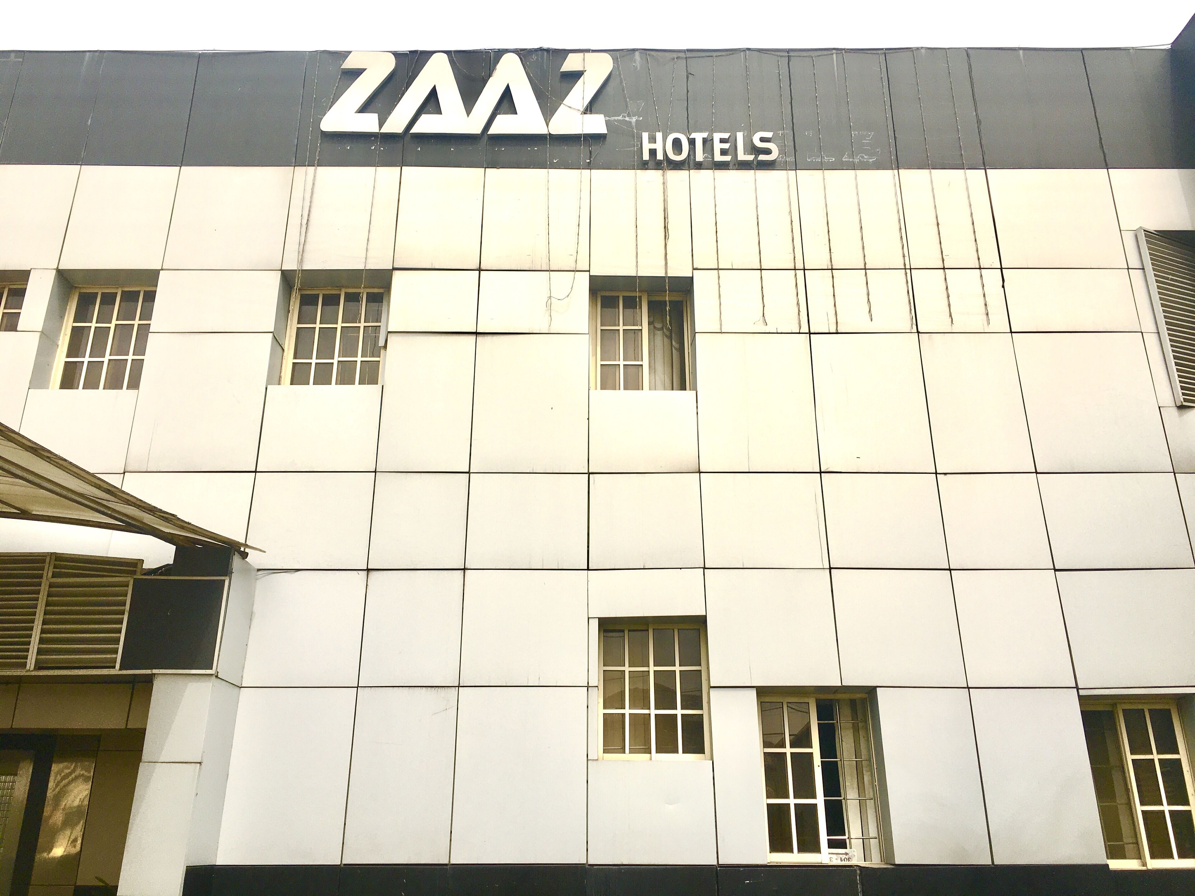 Un immeuble dont la façade porte l’enseigne « ZAAZ HOTELS ».