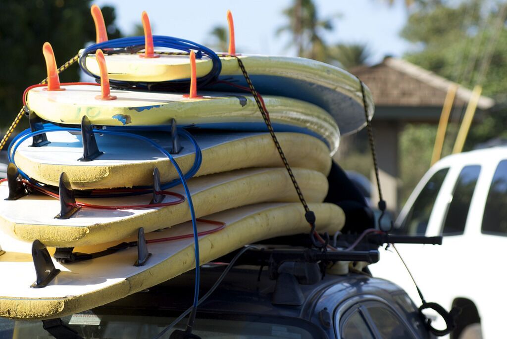 A stack of surfboards secured on a vehicle.
