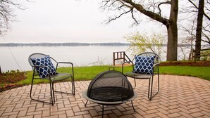 A patio with two chairs and a fire pit.