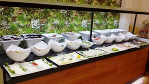 A buffet with various food items and bowls. - Guleryuz Otel (Ankara)