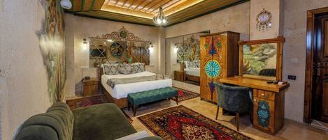 A bedroom with a bed, a desk, a chair, and a large mirror.