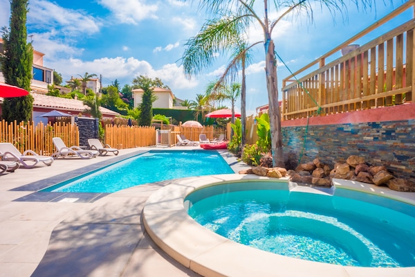 Een seizoensgebonden buitenzwembad en parasols bij het zwembad