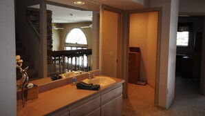 A modern bathroom with a large mirror, a double sink, and a vanity. - Whitefish Mountain 7 Bedroom Townhouse (Whitefish)
