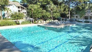 A rectangular swimming pool with clear blue water, surrounded by lounge chairs and a white fence. - Very Desirable 1st Floor Villa at Fiddler's Cove Beach & Racquet Club (Hilton Head Island)