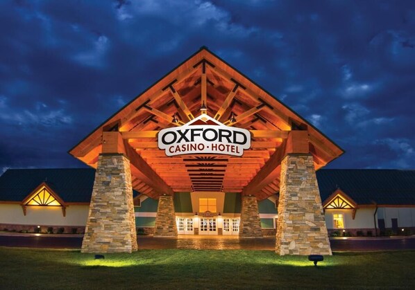 The exterior of the Oxford Casino Hotel with a prominent sign, stone pillars, and a covered entrance.