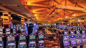 A casino with numerous slot machines and a high ceiling with exposed beams. - Oxford Casino Hotel (Oxford)