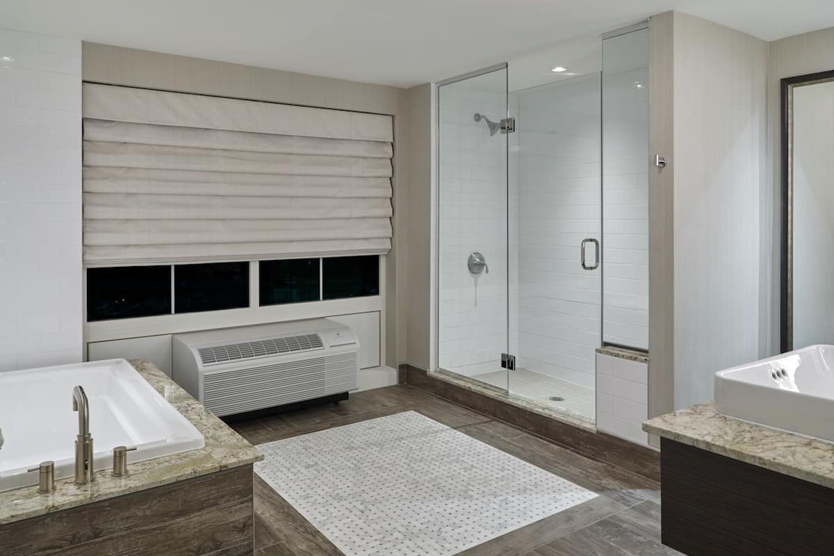 classic studio suite | bathroom | shower, hair dryer, towels