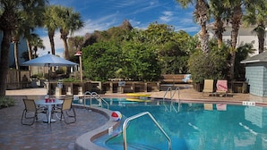 A swimming pool with a diving board, lounge chairs, and a covered patio area. - Relaxing getaway, with picturesque views, & a short walk to St. Augustine beach. (St. Augustine)