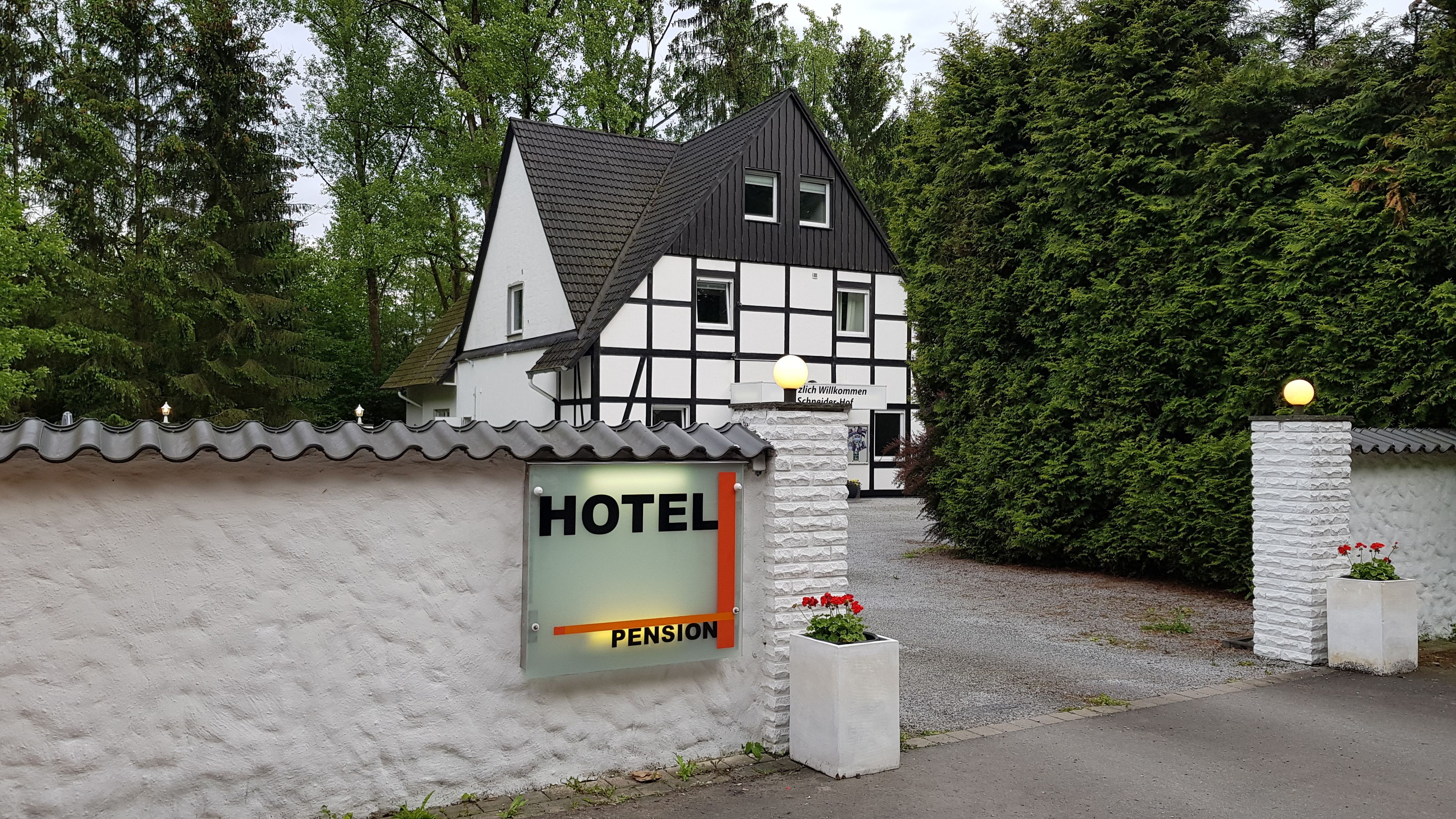 A traditional half-timbered building with a sign reading "HOTEL PENSION".