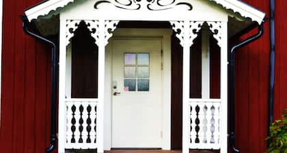 Outdoor place with furniture and barbeque, boat in lake