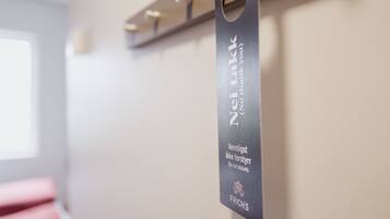 A sign with text in a foreign language, possibly indicating a room or area name.