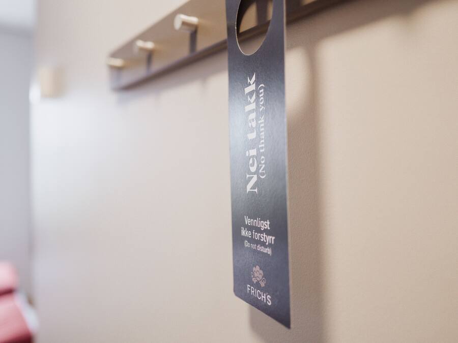 A sign with text in a foreign language, possibly indicating a room or area name.