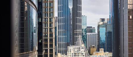A cityscape with modern high-rise buildings, a historic building with a dome, and a clear view of the streets below.