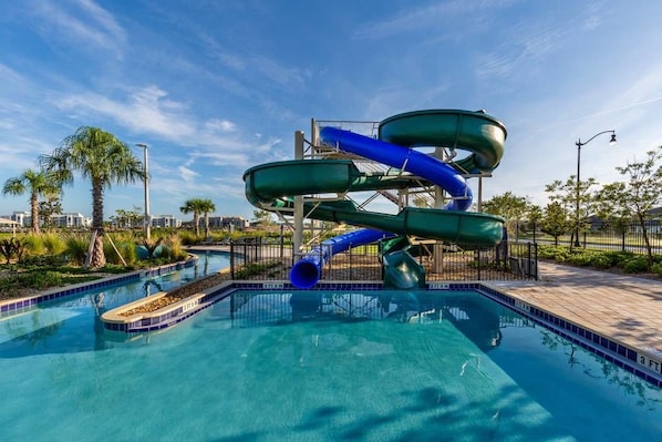A water park with a multi-level water slide structure and a pool.