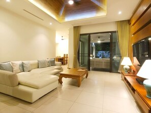 Relax in this spacious living room with a large sofa, coffee table, and flat-screen TV.