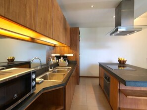 Enjoy cooking in this well-equipped kitchen with a double sink, oven, and microwave.