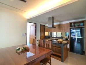 Enjoy meals in the kitchen with a central island and dining area featuring a table and chairs.
