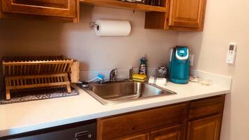 Fridge, microwave, coffee/tea maker, cookware/dishes/utensils