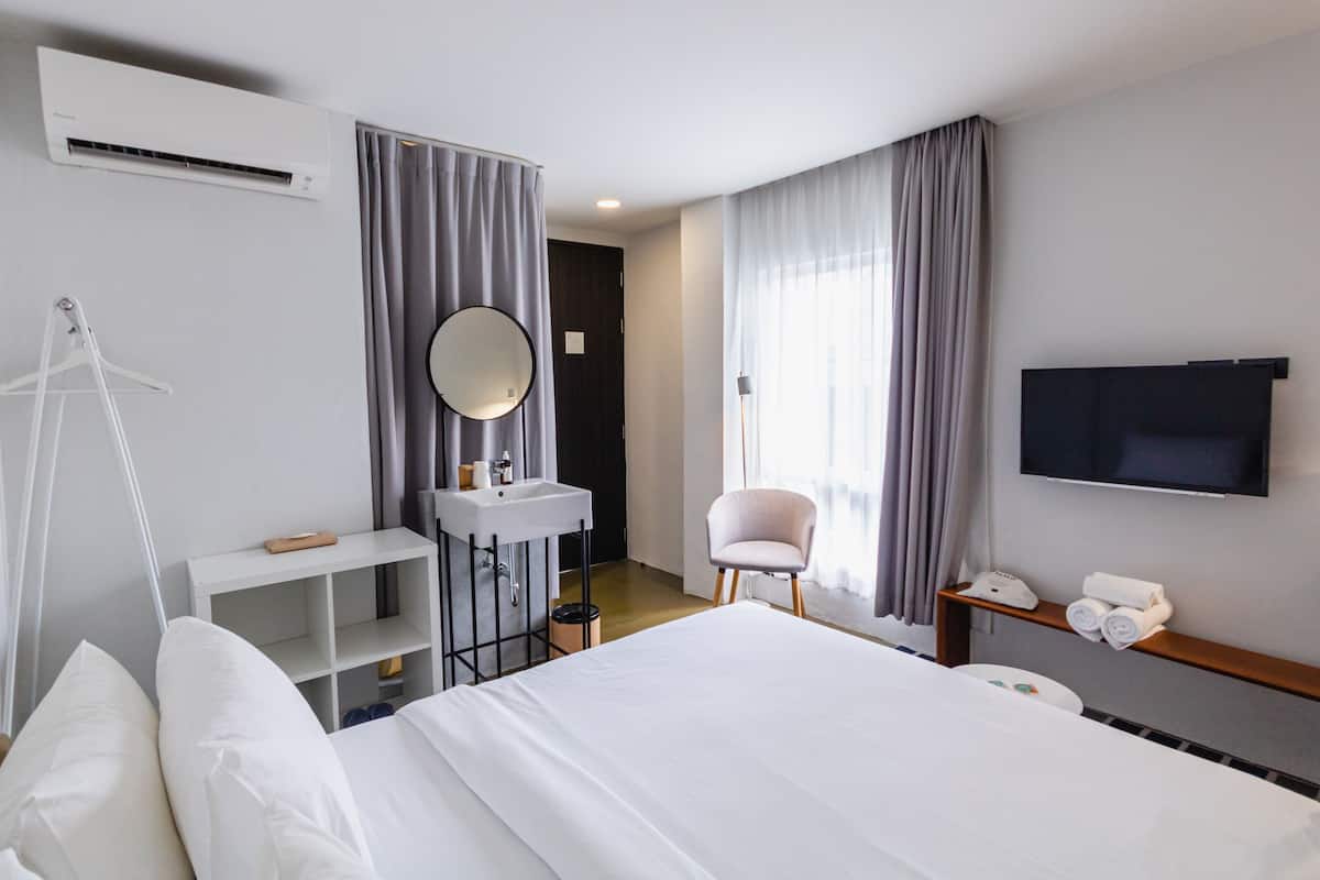 Hypo-allergenic bedding, desk, laptop workspace, blackout curtains