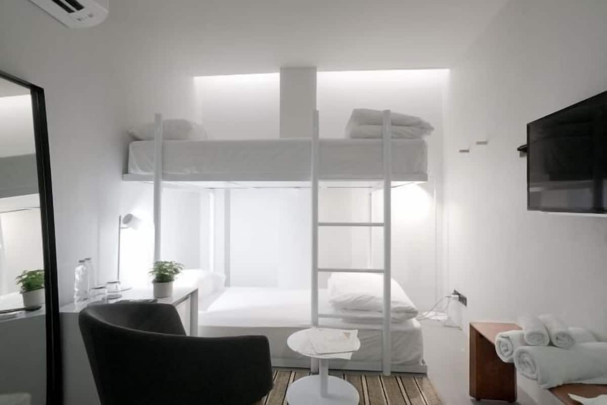 Hypo-allergenic bedding, desk, laptop workspace, blackout curtains