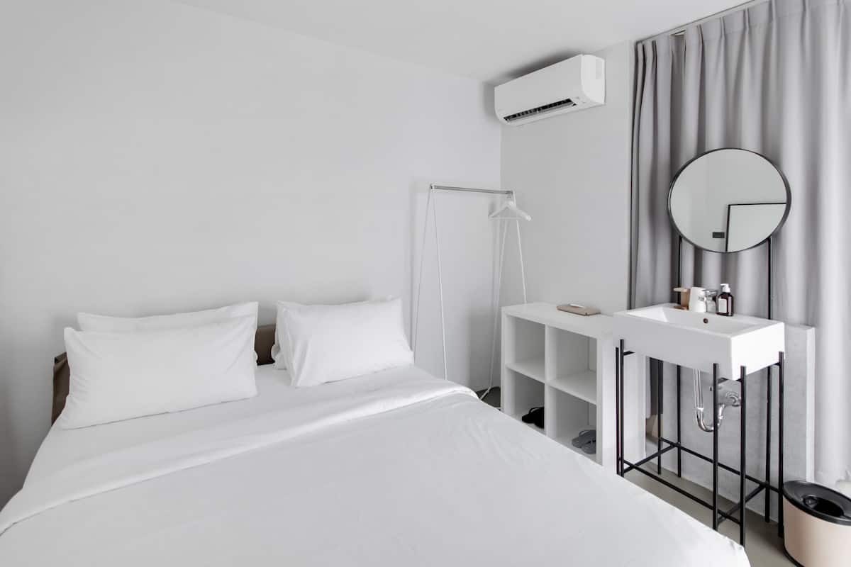 Hypo-allergenic bedding, desk, laptop workspace, blackout curtains
