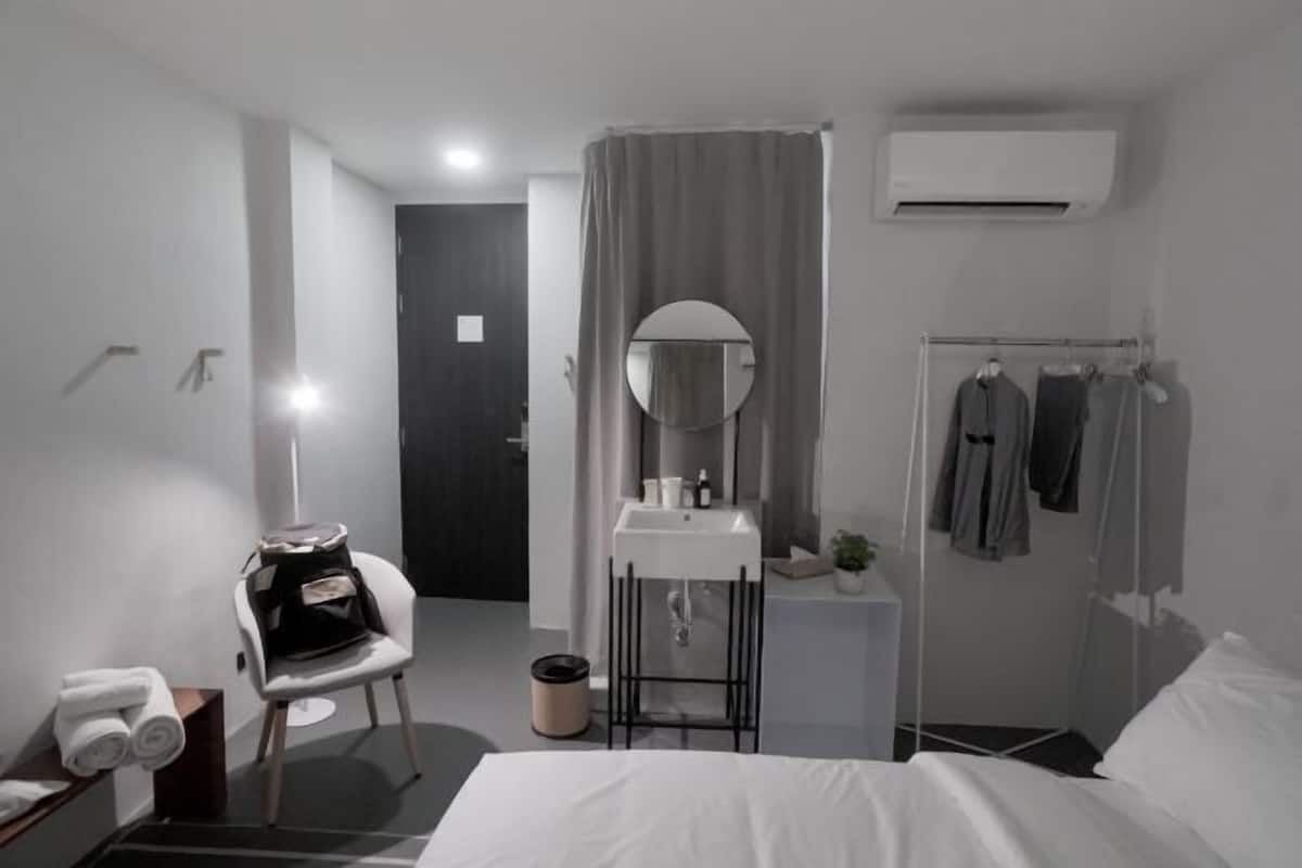 Hypo-allergenic bedding, desk, laptop workspace, blackout curtains